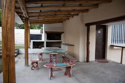 a patio with a table and chairs in a building at Silencio Dorado in Villa Serranita