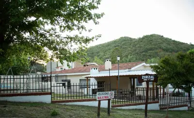 a house with a sign in front of it at Silencio Dorado in Villa Serranita