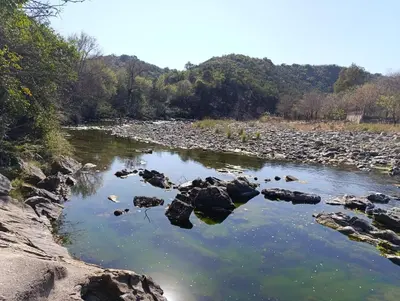 a river with rocks in the water at Silencio Dorado in Villa Serranita