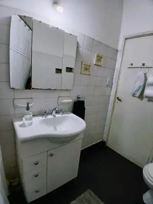 a bathroom with a sink and a mirror and a toilet at Habitación privada zona Centro, Tribunales y Patio Olmos in Cordoba