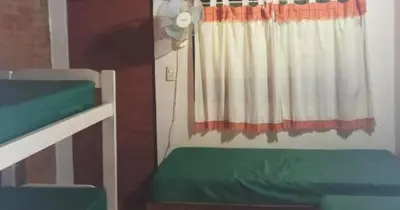 a room with two bunk beds and a window at Cabañas La Petunia in Santa Rosa de Calamuchita