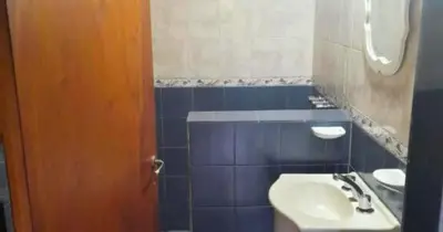a bathroom with a sink and a toilet at Cabañas La Petunia in Santa Rosa de Calamuchita