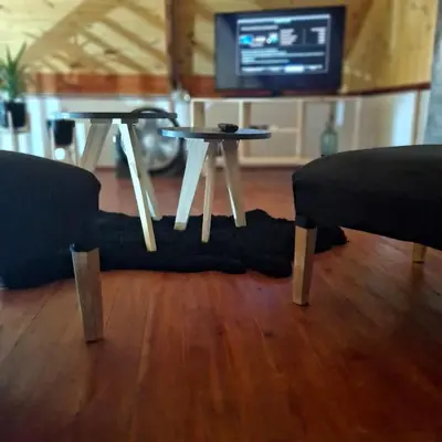 a living room with a table and a couch and a tv at Cima Capri Cabañas in Villa Carlos Paz