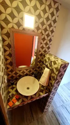 a bathroom with a sink and a mirror at La Moradita Villa Carlos Paz in Villa Carlos Paz