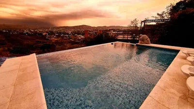 a swimming pool with a view of a city at La Moradita Villa Carlos Paz in Villa Carlos Paz