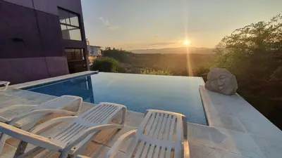 a group of chairs sitting next to a swimming pool at La Moradita Villa Carlos Paz in Villa Carlos Paz