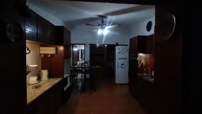 a kitchen with a white refrigerator and a table at Acogedora Casa Familiar en Zona Residencial in Cordoba