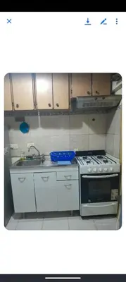 a kitchen with a stove and a sink at Monoambiente Cerro in Villa Carlos Paz