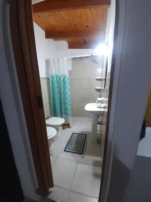 a bathroom with a toilet and a sink at Monoambiente Cerro in Villa Carlos Paz