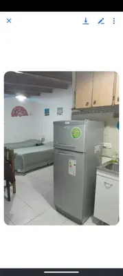 a kitchen with a refrigerator in a room at Monoambiente Cerro in Villa Carlos Paz
