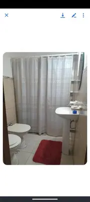 a bathroom with two toilets and a sink and a shower at Monoambiente Cerro in Villa Carlos Paz