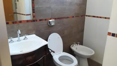 a bathroom with a sink and a toilet at Cabañas El Conejo Negro in Villa Cura Brochero