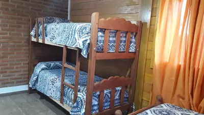 a couple of bunk beds in a room at Cabañas El Conejo Negro in Villa Cura Brochero