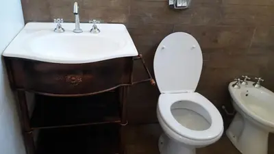 a bathroom with a sink and a toilet at Cabañas El Conejo Negro in Villa Cura Brochero
