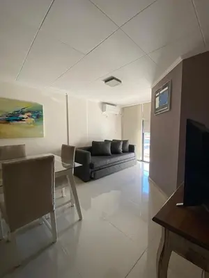 a living room with a couch and a table at Depto Centrico Exclusivo in Villa Carlos Paz