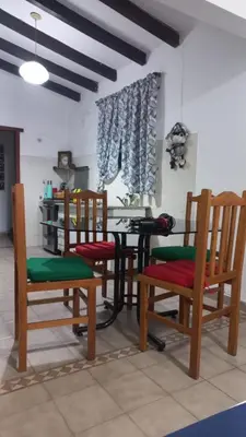 a room with chairs and a table in a room at Casa y cabaña de Gachy in Villa Carlos Paz