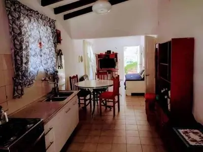 a kitchen with a table and chairs and a dining room at Casa y cabaña de Gachy in Villa Carlos Paz