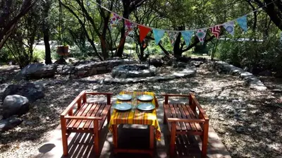 a picnic table with two chairs and plates and flags at Cielito lindo in San Javier