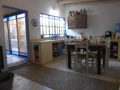 a kitchen with a table and chairs in a room at Cielito lindo in San Javier