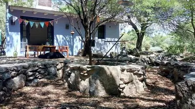 a stone retaining wall in front of a house at Cielito lindo in San Javier