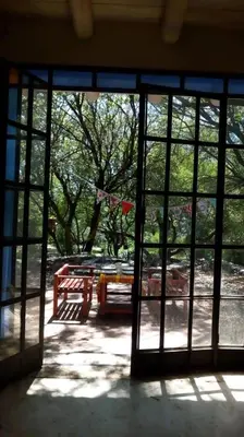 an open glass door with a bench in a park at Cielito lindo in San Javier