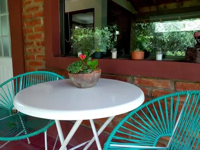 a white table and chairs with a potted plant on it at Dorado del Sol in Merlo