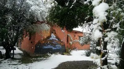 a building with a painting on it in the snow at Dorado del Sol in Merlo