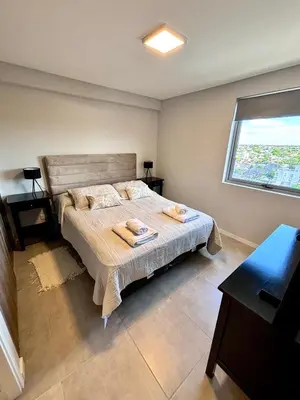 a bedroom with a bed with two towels on it at Departamento moderno y lujoso con gym y piscina in Cordoba