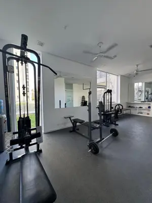 a gym with two treadmills and weights in a room at Departamento moderno y lujoso con gym y piscina in Cordoba