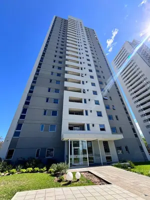 a tall white building with two tall buildings at Departamento moderno y lujoso con gym y piscina in Cordoba