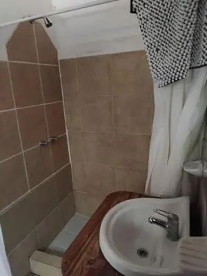 a bathroom with a sink and a shower at Hotel del Alto in Nono