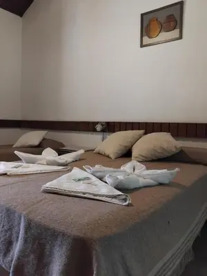 a group of three beds with towels on them at Hotel del Alto in Nono