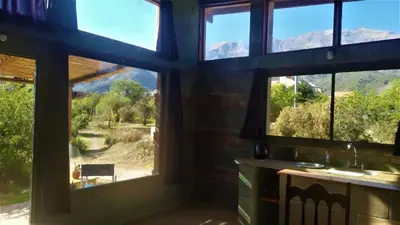 a room with a window with a view of the mountains at Sol de Los Nogales in Merlo
