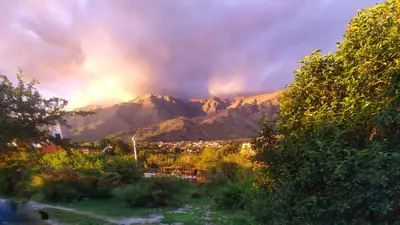 a view of a mountain range with a rainbow in the sky at Sol de Los Nogales in Merlo