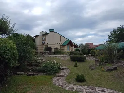a house with a garden in front of it at Champ Cervi in San Antonio de Arredondo