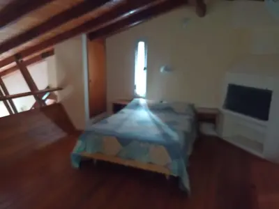 a bedroom with a bed in a room with a window at Champ Cervi in San Antonio de Arredondo