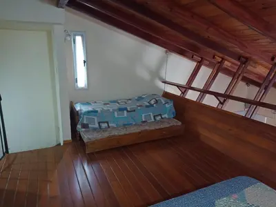 a bedroom with a bed in the corner of a room at Champ Cervi in San Antonio de Arredondo