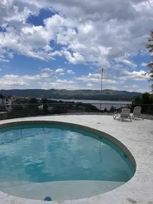 a small swimming pool with a view of the water at La Serena in Villa Carlos Paz