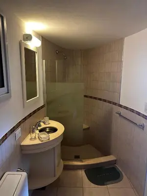 a bathroom with a sink and a shower at La Serena in Villa Carlos Paz