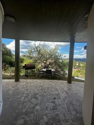 a view of a patio with a table and a tree at La Serena in Villa Carlos Paz