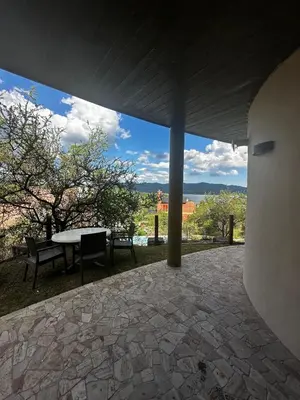 a view of a patio with a table and chairs at La Serena in Villa Carlos Paz