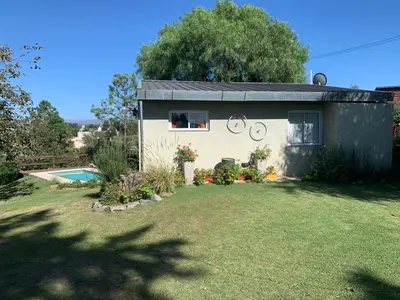 a small house with a yard and a pool at Estacion Potrero cabaña chica in Potrero de Garay