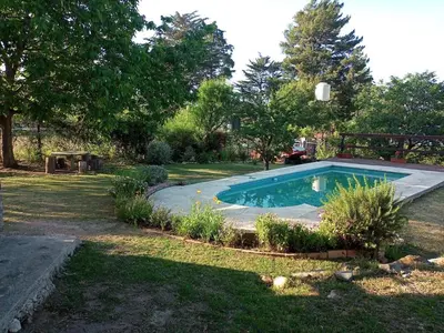 a small swimming pool in a yard with trees at Estacion Potrero cabaña chica in Potrero de Garay