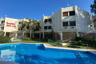 a building with a swimming pool in front of a building at Departamento Villa Carlos Paz in Villa Carlos Paz