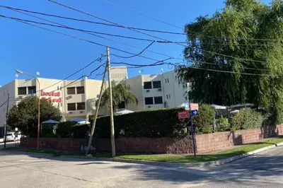 an empty street with buildings in the background at Departamento Villa Carlos Paz in Villa Carlos Paz