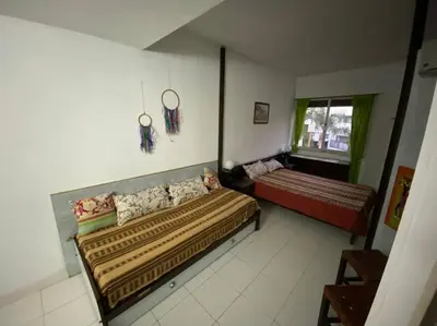 a living room with a bed and a window at Departamento Villa Carlos Paz in Villa Carlos Paz