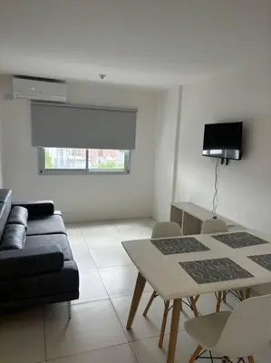 a living room with a table and a couch at Departamento para 2 personas in Cordoba