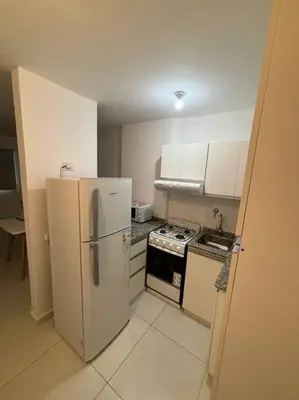 a small kitchen with a refrigerator and a stove at Departamento para 2 personas in Cordoba