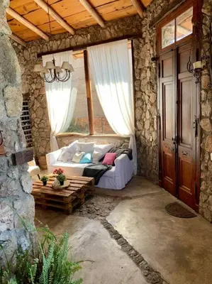 a living room with a couch in a stone house at Casa de ensueño in Villa Carlos Paz