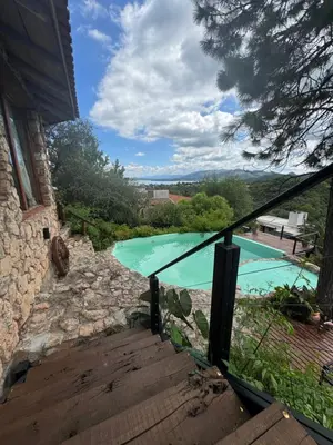 a view of a swimming pool from the stairs of a house at Casa de ensueño in Villa Carlos Paz